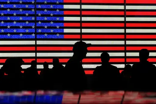People stand in Times Square in New York, Aug. 9, 2024. (AP Photo/Pamela Smith, File)