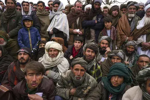 Hundreds of Afghan men gather to apply for the humanitarian aid in Qala-e-Naw, Afghanistan, Tuesday, Dec. 14, 2021. In a statement Tuesday, Jan. 11, 2022, the White House announced $308 million in additional humanitarian assistance for Afghanistan, offering new aid to the country as it edges toward a humanitarian crisis since the Taliban takeover nearly five months earlier. (AP Photo/Mstyslav Chernov, File)