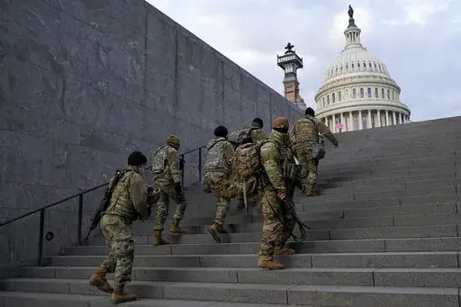 National Guard members take a staircase toward the U.S. Capitol building before a rehearsal for President-elect Joe Biden's Presidential Inauguration in Washington, Jan. 18, 2021. Soldiers are leaving the Army National Guard at a faster rate than they are enlisting, fueling concerns that in the coming years units around the country may not meet military requirements for overseas and other deployments. Officials say the number of soldiers retiring or leaving the Guard each month in the past year 