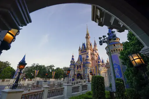 The newly painted Cinderella Castle at the Magic Kingdom at Walt Disney World is seen with the the crest to celebrate the 50th anniversary of the theme park on Aug. 30, 2021, in Lake Buena Vista, Fla. Officials at Walt Disney World say a performance by a visiting Texas high school drill team that used American Indian stereotypes, including chants of “scalp them,” doesn’t reflect the resort’s values. A Disney spokeswoman said Friday, March 18, 2022, that the company regretted the performa