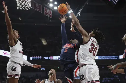 Mississippi guard Jaylen Murray (5) scores and is fouled by South Carolina forward Collin Murray-Boyles (30) during the first half of an NCAA college basketball game Tuesday, Feb. 6, 2024, in Columbia, S.C. (AP Photo/Artie Walker Jr.)