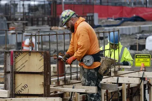 A construction worker wires rebar for a foundation, Friday, March 17, 2023, in Boston. On Friday, the U.S. government issues the August jobs report. (AP Photo/Michael Dwyer, File)