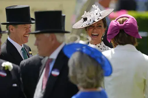 Kate, Duchess of Cambridge, second right, laughs as she stands in the paddock on the fourth day of the Royal Ascot horserace meeting, at Ascot Racecourse, in Ascot, England, Friday, June 17, 2022. Every June, Britain's royals, aristocrats and thousands of stylish guests don their finest headgear for Royal Ascot, a glamorous annual horse racing event that dates back to 1711, when Queen Anne founded Ascot Racecourse in Berkshire, southern England. (AP Photo/Alastair Grant)