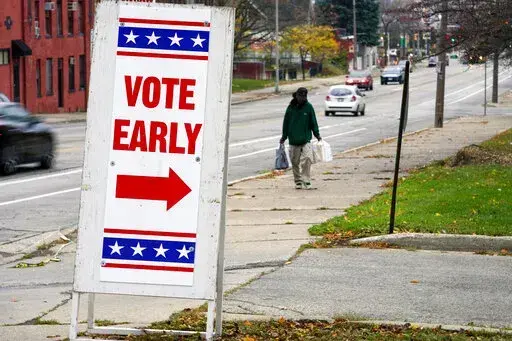 A sign is seen outside a polling station Tuesday, Oct. 25, 2022, in Milwaukee. Tuesday is the first day to vote early in Wisconsin. (AP Photo/Morry Gash)