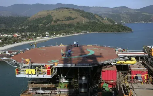 Petrobras workers walk on platform 51 "Majuro" in Angra dos Reis, Brazil, Aug. 21, 2008. (AP Photo/Ricardo Moraes, File)