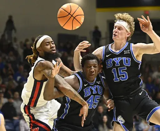 Mississippi forward Mikeal Brown-Jones (1) fights for a rebound with BYU center Fousseyni Traore (45) and forward Richie Saunders (15) during the second half of an NCAA college basketball game Thursday, Nov. 28, 2024, in San Diego. (AP Photo/Denis Poroy)