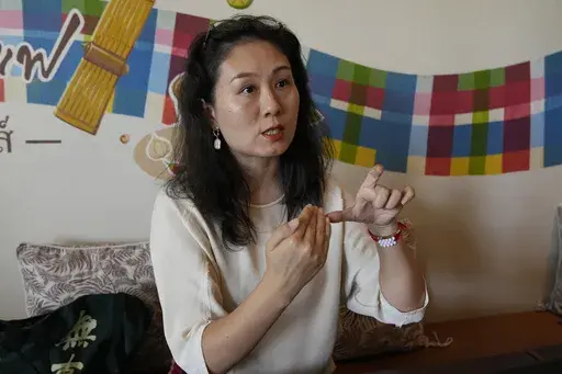 Chinese mother Du Xuan gestures during an interview with The Associated Press in Chiang Mai province, Thailand, Tuesday, April 23, 2024. (AP Photo/Sakchai Lalit)