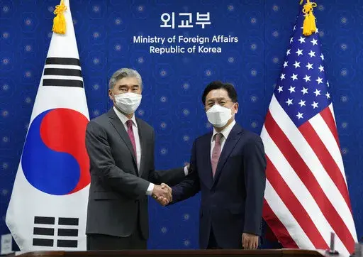 U.S. Special Representative for North Korea, Sung Kim, left, shakes hands with South Korea's Special Representative for the Korean Peninsula Peace and Security Affairs Noh Kyu-duk as they pose for a photo during a meeting at the Foreign Ministry in Seoul, South Korea, Monday, April 18, 2022. (AP Photo/Ahn Young-joon, Pool)