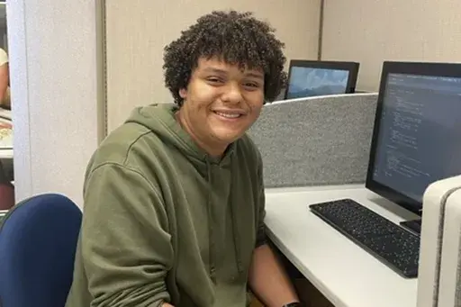 In the photo provided by Jaden Todd, Northern Virginia Community College student Jaden Todd, 21, sits a computer terminal on campus, Thursday, Nov 9, 2023, in Annandale, VA. Todd has plans to transfer to George Mason University to finish a degree in computer science. (Jaden Todd via AP)