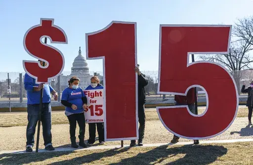 Activists appeal for a $15 minimum wage near the Capitol in Washington, Feb. 25, 2021. (AP Photo/J. Scott Applewhite, File)