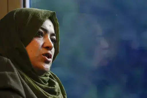 Batool Haidari, 37, talks during an interview with the Associated Press on a train taking her from her home on the outskirts of Rome, to the capital's center, Monday, Dec. 5, 2022. Batool Haidari was a prominent professor of sexology at a university in Kabul before last year’s Taliban takeover of Afghanistan. She used to lecture mixed classes of male and female students and look after her patients struggling with their gender identity. That comfortable life came to an abrupt halt on Aug. 15, 2