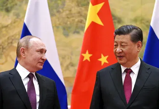Chinese President Xi Jinping, right, and Russian President Vladimir Putin talk to each other during their meeting in Beijing, China on Feb. 4, 2022. Three weeks ago, on the eve of the Beijing Winter Olympics, the leaders of China and Russia declared that the friendship between their countries "has no limits." But that was before Russia's invasion of Ukraine, a gambit that will test just how far China is willing to go. (Alexei Druzhinin, Sputnik, Kremlin Pool Photo via AP, File)
