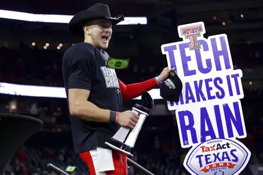 Texas Tech quarterback Tyler Shough waves a sign after the team's 42-25 win over Mississippi in the Texas Bowl NCAA college football game, early Thursday, Dec. 29, 2022, in Houston. (AP Photo/Michael Wyke)