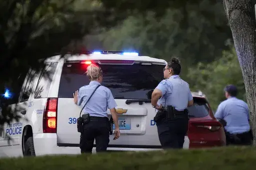 Police take up positions near the scene of a shooting Saturday, Aug. 29, 2020, in St. Louis. Ten years after gaining local control of its police for the first time since the Civil War, the city of St. Louis has even more murders than before — and Missouri lawmakers are again considering a state takeover of the police force. (AP Photo/Jeff Roberson, File)