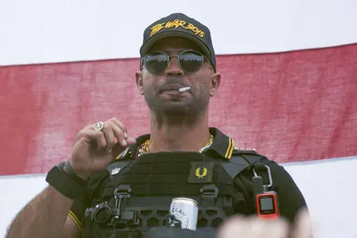 Proud Boys leader Henry "Enrique" Tarrio wears a hat that says The War Boys during a rally in Portland, Ore., on Sept. 26, 2020. The Justice Department said Thursday, Aug. 17, 2023, it is seeking 33 years in prison for Tarrio, convicted of seditious conspiracy in one of the most serious cases to emerge from the Jan. 6, 2021, attack on the U.S. Capitol. (AP Photo/Allison Dinner, File)