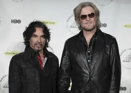 Hall of Fame Inductees, Hall & Oates, John Oates and Daryl Hall appear in the press room at the 2014 Rock and Roll Hall of Fame Induction Ceremony on April, 10, 2014, in New York. Hall has sued his longtime music partner John Oates, arguing that his plan to sell off his share of a joint venture would violate a business agreement the duo had. (Photo by Andy Kropa/Invision/AP, File)