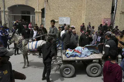 Palestinians carry the bodies of their relatives who were killed in an Israeli airstrike in Shijaiyah neighborhood, as they brought to the Baptist Hospital in Gaza City on Wednesday, April 9, 2025. (AP Photo/Jehad Alshrafi)