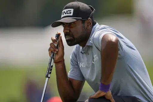 Sahith Theegala lines up his putt on the third green during the final round of the Tour Championship golf tournament, Sunday, Sept. 1, 2024, in Atlanta. (AP Photo/Mike Stewart)