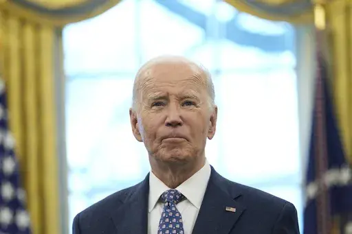 President Joe Biden pauses during a photo opportunity with Medal of Valor recipients in the Oval Office of the White House in Washington, Jan. 3, 2025. (AP Photo/Susan Walsh, File)