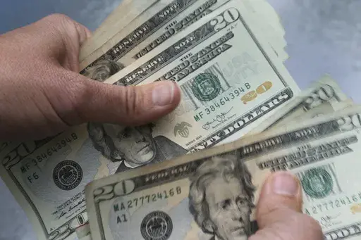 In this June 15, 2018 photo, twenty dollar bills are counted in North Andover, Mass. As the middle of the year approaches, it’s a smart time to check in on the money goals you set back in January and make any necessary adjustments. If you didn’t create goals, it’s not too late to establish them for the second half of the year. First, define or update what your goals are. (AP Photo/Elise Amendola, File)