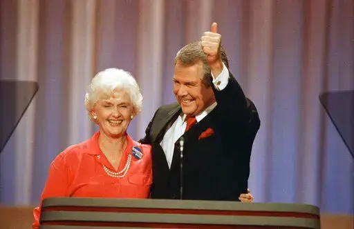 Former Republican presidential hopeful Pat Robertson gives a thumbs-up as he and his wife, Dee Dee, acknowledge applause at the Republican National Convention in New Orleans, Tuesday, August 17, 1988. Adelia “Dede” Robertson, the wife of religious broadcaster Pat Robertson as well as an author and founding board member of the Christian Broadcasting Network, died Tuesday, April 19, 2022, at her home in Virginia Beach. She was 94. (AP Photo/Ron Edmonds, File)