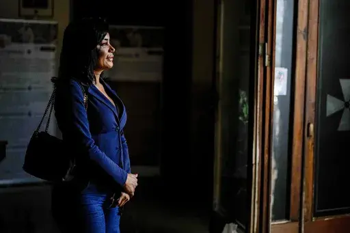 Carla Segovia, a transgender woman from Argentina, walks out of the Beata Vergine Immacolata parish church in Torvaianica, Italy, Thursday, Nov. 16, 2023. Pope Francis’ recent gesture of welcome for transgender Catholics has resonated strongly in this working class, seaside town south of Rome, where a community of trans women has found help and hope through a remarkable friendship with the pontiff forged during the darkest times of the pandemic. (AP Photo/Andrew Medichini)