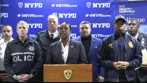 This photo provided by NYPD, New York City Police Commissioner Keechant Sewell address the media during a news conference on Saturday, Dec. 31, 2022. A man wielding a machete attacked three police officers at the New Year’s Eve celebration in New York City, authorities said, striking two of them in the head before an officer shot the man in the shoulder. The two officers were hospitalized, one with a fractured skull and the other with a bad cut, but expected to recover. (NYPD via AP)