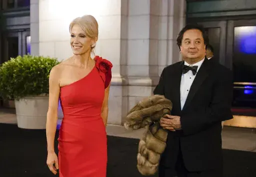 President-elect Donald Trump adviser Kellyanne Conway accompanied by her husband, George, speaks with members of the media as they arrive for a dinner at Union Station on Jan. 19, 2017, in Washington, the day before Trump's inauguration. The couple posted a joint statement on their Twitter accounts Saturday, March 4, 2023, announcing they are divorcing. (AP Photo/Matt Rourke, File)