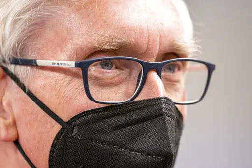 Wisconsin Gov. Tony Evers listens during a gathering of about 50 Democrats at a party headquarters Saturday, Jan. 8, 2022, in Janesville, Wis. The 70-year-old grandfather and former teacher is trying to convince voters that he's also a valiant defender of democracy and the lone figure ensuring their votes will still matter in 2024 and beyond. (AP Photo/Andy Manis)