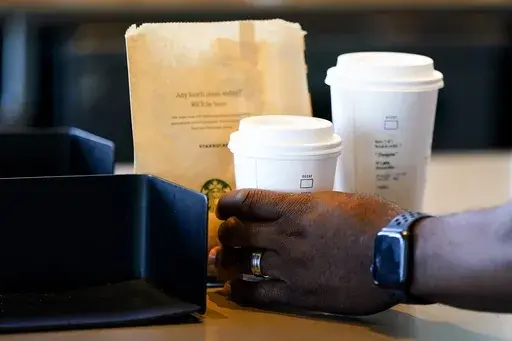 A customer picks up a drink at a Starbucks on June 28, 2023, in Seattle.(AP Photo/Lindsey Wasson, File)