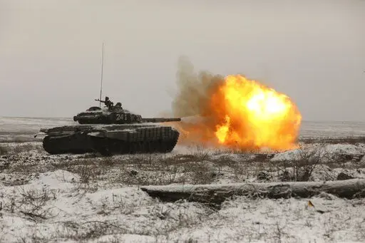 A Russian tank T-72B3 fires as troops take part in drills at the Kadamovskiy firing range in the Rostov region in southern Russia, on Jan. 12, 2022. The failure of last week's high-stakes diplomatic meetings to resolve escalating tensions over Ukraine has put Russia, the United States and its European allies in uncharted post-Cold War territory.(AP Photo)