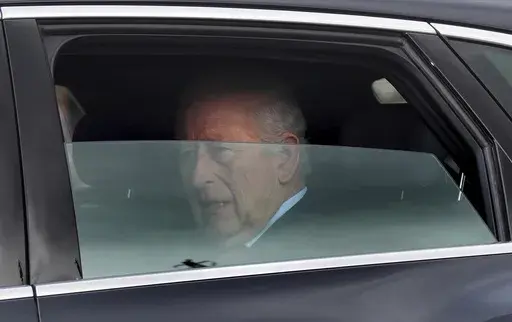 Britain's King Charles III is driven by car from Clarence House, his London home, along The Mall towards Buckingham Palace in London, Friday, March 28, 2025. (Yui Mok/PA via AP)