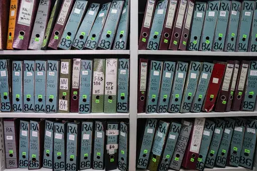 Archive folders line the shelves at the Documentation and Archive Foundation of the Vicariate of Solidarity, in Santiago, Chile, Tuesday, July 25, 2023. The shelves preserve thousands of instances of human rights violations during the dictatorship of Augusto Pinochet. (AP Photo/Esteban Felix)