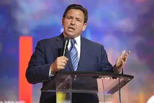 Florida's Republican Gov. Ron DeSantis addresses attendees during the Turning Point USA Student Action Summit, Friday, July 22, 2022, in Tampa, Fla. DeSantis' effort to place candidates fully aligned with his conservative views on school boards throughout the state is helping him expand his influence. Of the 30 candidates endorsed by DeSantis in the Aug. 23 elections, 19 won, five lost and six are headed to runoffs. (AP Photo/Phelan M. Ebenhack, File)