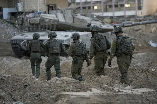 Israeli soldiers are seen during a ground operation in the Gaza Strip, Wednesday, Nov. 8, 2023. Prime Minister Benjamin Netanyahu did not elaborate this week when he said that Israel would maintain indefinite "overall security responsibility" in Gaza once it removes Hamas from power in response to a bloody Oct. 7 cross-border raid by the Islamic militant group. That could complicate any plans to hand governing responsibility to the Palestinian Authority or friendly Arab states, and bog Israel do