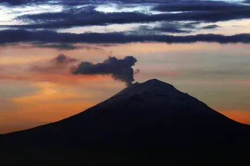 A plume of ash and steam rises from the Popocatepetl volcano, as seen from Mexico City, Wednesday, June 19, 2019. Popocatepetl rumbled to life again this third week of May 2023, spewing out towering clouds of ash that forced 11 villages to cancel school sessions. (AP Photo/Marco Ugarte, File)