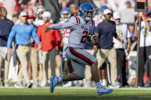 Mississippi quarterback Jaxson Dart (2) runs the ball against Alabama during the second half of an NCAA college football game, Saturday, Sept. 23, 2023, in Tuscaloosa, Ala. (AP Photo/Vasha Hunt)
