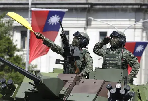 Taiwanese soldiers salute during National Day celebrations in front of the Presidential Building in Taipei, Taiwan, on Oct. 10, 2021. (AP Photo/Chiang Ying-ying, File)