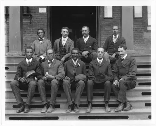 This 1902 portrait provided by The Library of Congress shows George Washington Carver, front row, center, seated with other staff members on the steps of Tuskegee Normal and Industrial Institute in Tuskegee, Alabama. (Frances Benjamin Johnston/Library of Congress via AP)