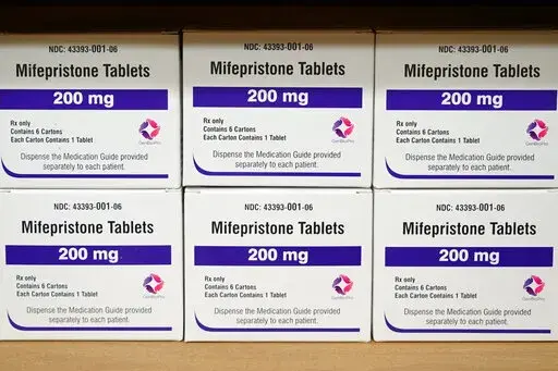 Boxes of the drug mifepristone sit on a shelf at the West Alabama Women's Center in Tuscaloosa, Ala., on March 16, 2022. Attorney generals in 20 conservative-led states warned CVS and Walgreens on Wednesday, Feb. 1, 2023, that they could face legal consequences if they sell abortion pills by mail in those states. (AP Photo/Allen G. Breed, File)