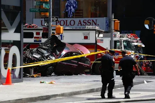 FILE- A smashed car sits on the corner of Broadway and 45th Street in New York's Times Square after several were injured when the car was driven into a crowd of pedestrians on May 18, 2017. Richard Rojas, the man behind the wheel of the car that barreled through crowds of pedestrians in New York City's Times Square, killing a woman and injuring 22 other people, is finally headed to trial, Monday, May 9, 2022, after various delays over five years, including pandemic-induced court shutdowns.(AP Ph