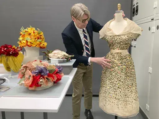 Curator Andrew Bolton displays garments in the conservation space of the Costume Institute of the Metropolitan Museum of Art in Manhattan, Nov. 8, 2023. The garments will be part of the upcoming spring exhibit at the Costume Institute, launched by the Met Gala. “Sleeping Beauties: Reawakening Fashion” will run from May 10-Sept. 2, 2024. (AP Photo/Jocelyn Noveck)