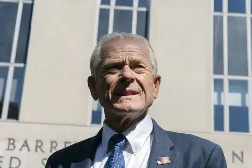 Former White House trade adviser Peter Navarro listens as his legal team talk to members of the media outside the federal court in Washington, Aug. 31, 2022. Navarro is scheduled to stand trial in September on contempt of Congress charges filed after he refused to cooperate with a congressional investigation into the Jan. 6 attack on the U.S. Capitol. A judge set the September 5 trial date on Tuesday. (AP Photo/Manuel Balce Ceneta, File)
