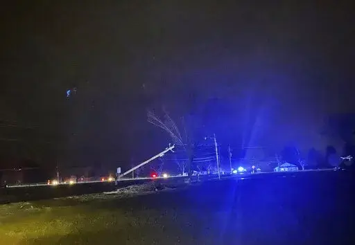 This photo provided by Madison County Sheriff's Office, authorities closed down a road after power lines came down and homes suffered damage early Sunday, Jan. 2, 2022 in Hazel Green, Ala. The storms followed a system earlier Saturday which brought a possible tornado and flooding to parts of Kentucky. (Madison County Sheriff's Office via AP)
