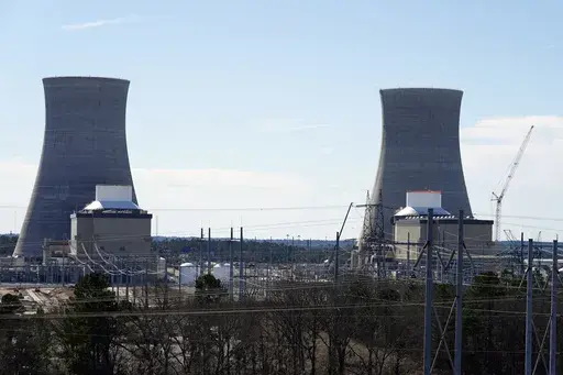 Units 3, left, and 4 and their cooling towers stand at Georgia Power Co.'s Plant Vogtle nuclear power plant, Jan. 20, 2023, in Waynesboro, Ga. Georgia's Public Service Commission voted 5-0 on Tuesday, Dec. 19, 2023 to approve a 6% rate increase for remaining costs that will take effect once Unit 4 begins commercial operation. (AP Photo/John Bazemore, File)