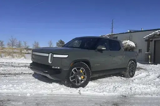 This photo provided by Edmunds shows a Rivian R1T electric pickup near Boulder, Colorado. Many of the potential problems of driving an electric vehicle in cold weather can be offset by planning ahead. (Emme Hall/Edmunds via AP)