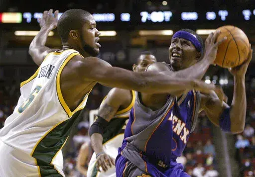 Seattle SuperSonics' Galen Young (5) guards Phoenix Suns' Quentin Richardson during the first half of a preseason basketball game Saturday, Oct. 16, 2004, in Seattle. A woman who crashed her car into a Memphis house has been charged with vehicular homicide in the death of Galen Young, a former college and pro basketball player found dead in the home, prosecutors said Tuesday, April 19, 2022.(AP Photo/Jim Bryant, File)