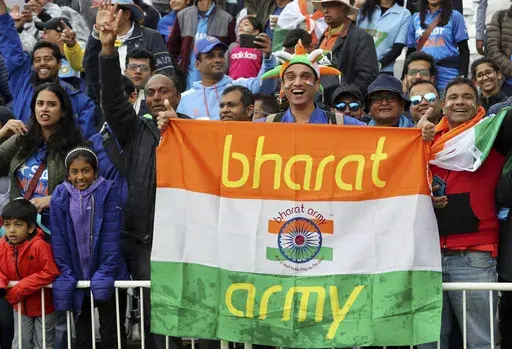 FILE- Indian cricket fans wait for the start of the Cricket World Cup match between India and New Zealand at Trent Bridge in Nottingham, Thursday, June 13, 2019. India has two official names: India, a nomenclature used and accepted in English communication worldwide, and a Sanskrit and Hindi appellation that is “Bharat.” This choice of name is now under spotlight, with Prime Minister Narendra Modi’s government making calls that Indians should rather call their country Bharat and not India.