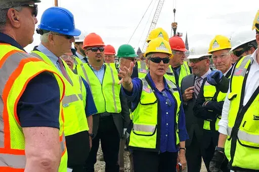 U.S. Energy Secretary Jennifer Granholm, center, tours the New London State Pier facility Friday, May 20, 2022 to view progress on a hub for the offshore wind power industry in New London, Conn. The U.S. energy secretary and Danish wind developer Orsted say they want American union workers to build offshore wind farms to dot the U.S. coastlines— the building trades workers who could otherwise be left out of the transition to relying more on renewable resources to reduce greenhouse gas emission