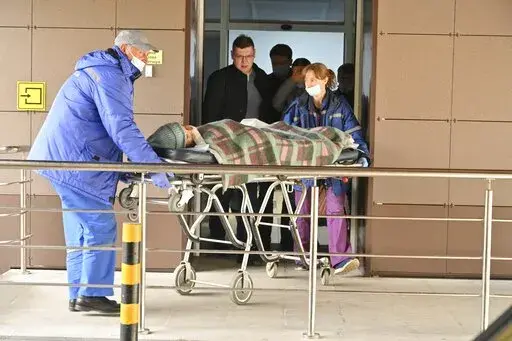 Medical staff carry an injured person on a stretcher at the emergency department of the First Republican Clinical hospital to evacuate to Moscow, in Izhevsk, Russia, Tuesday, Sept. 27, 2022. The plane of the Ministry of Emergency Situations will deliver victims of the shooting at school No. 88 in Izhevsk to Moscow hospitals. This was stated by the Presidential Commissioner for Children's Rights Maria Lvova-Belova. According to officials, 11 children were among those killed in the Monday morning 